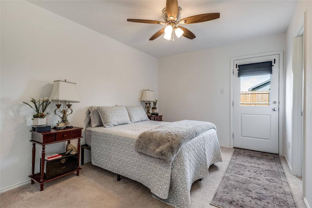 142 Sesame Lane Princeton, TX 75407 - Photo 7 of 15 a bedroom with a bed and a chandelier