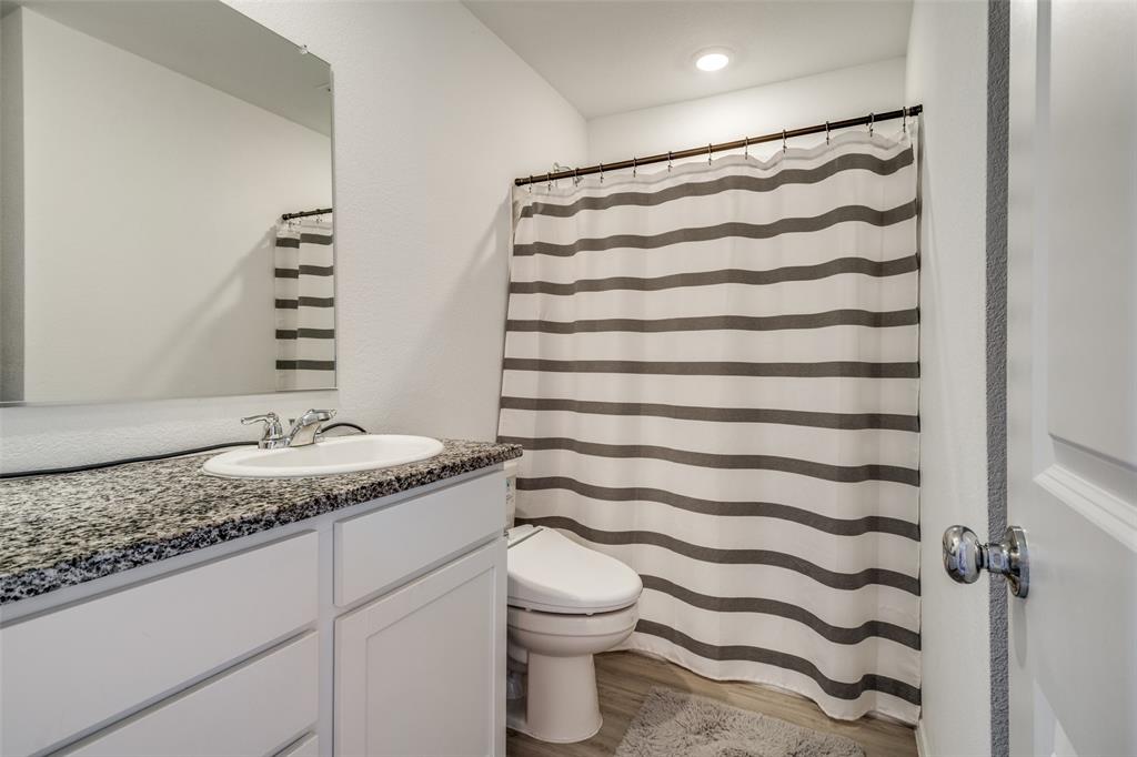 142 Sesame Lane Princeton, TX 75407 - Photo 8 of 15 a bathroom with a granite countertop sink and a mirror