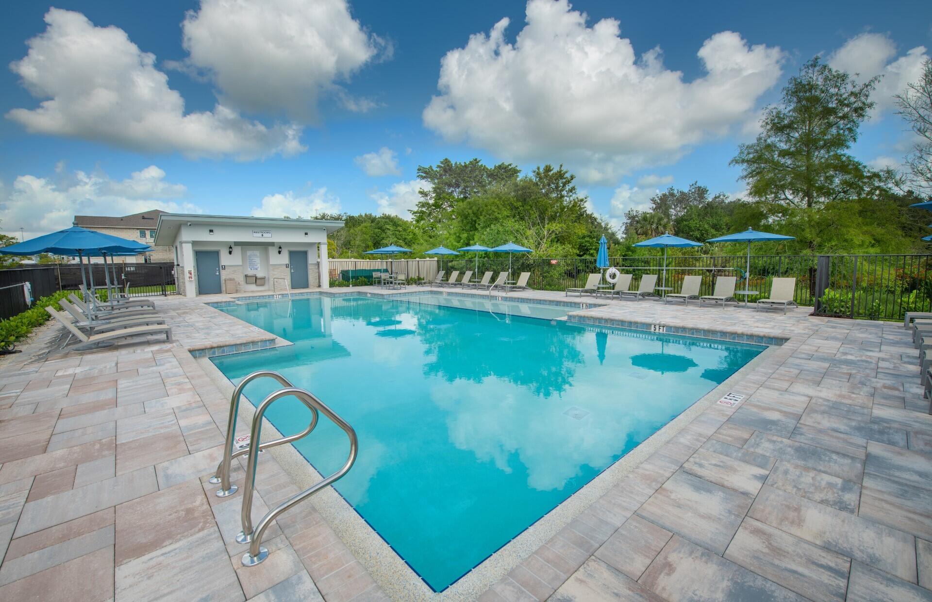 7790 Southwest Bentley Lane, Unit NAUTICAL 8015 Stuart, FL 34997 - Photo 19 of 22 a view of a swimming pool with a patio
