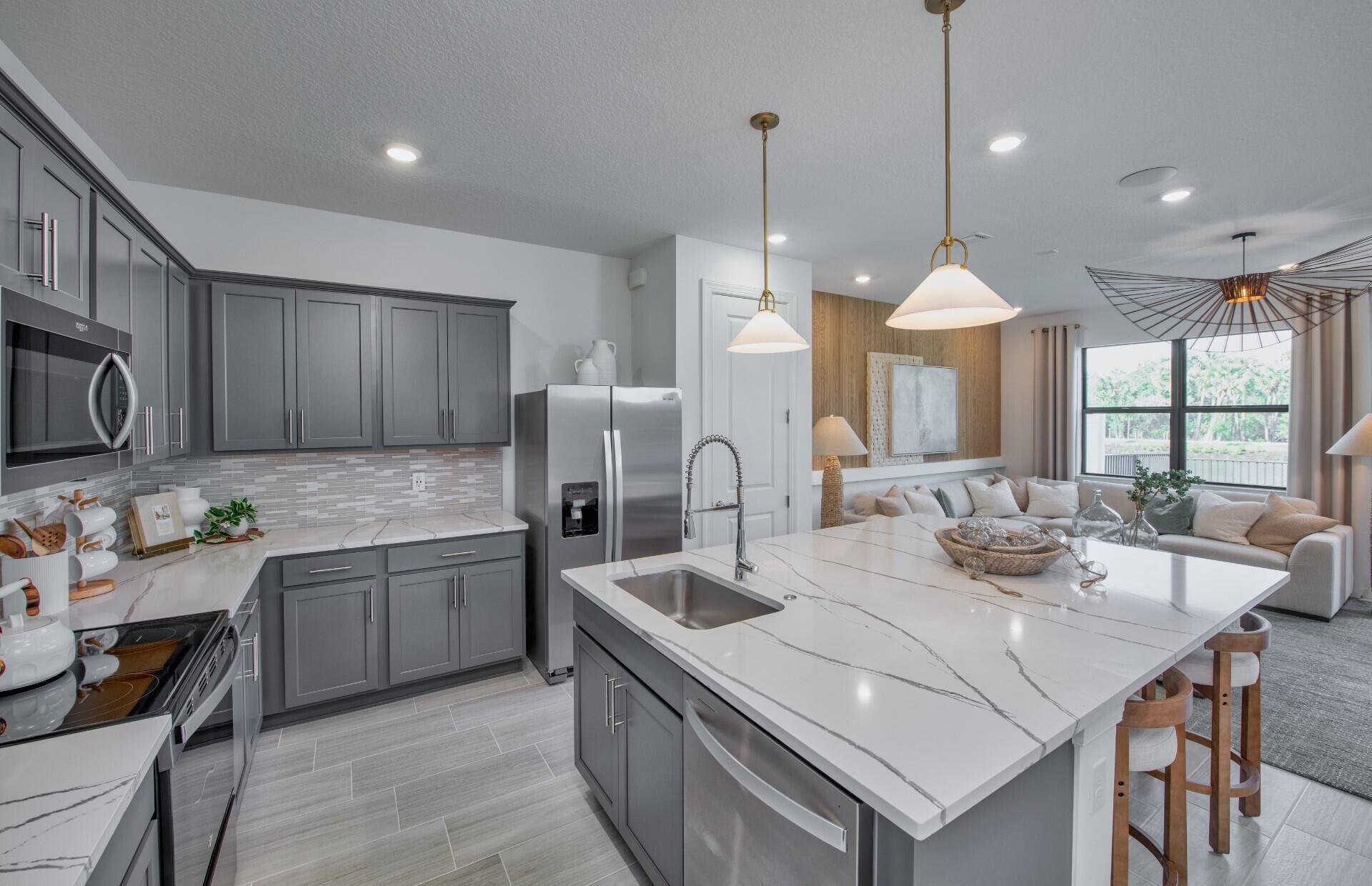 7790 Southwest Bentley Lane, Unit NAUTICAL 8015 Stuart, FL 34997 - Photo 4 of 22 a kitchen with stainless steel appliances granite countertop a sink a stove and a refrigerator