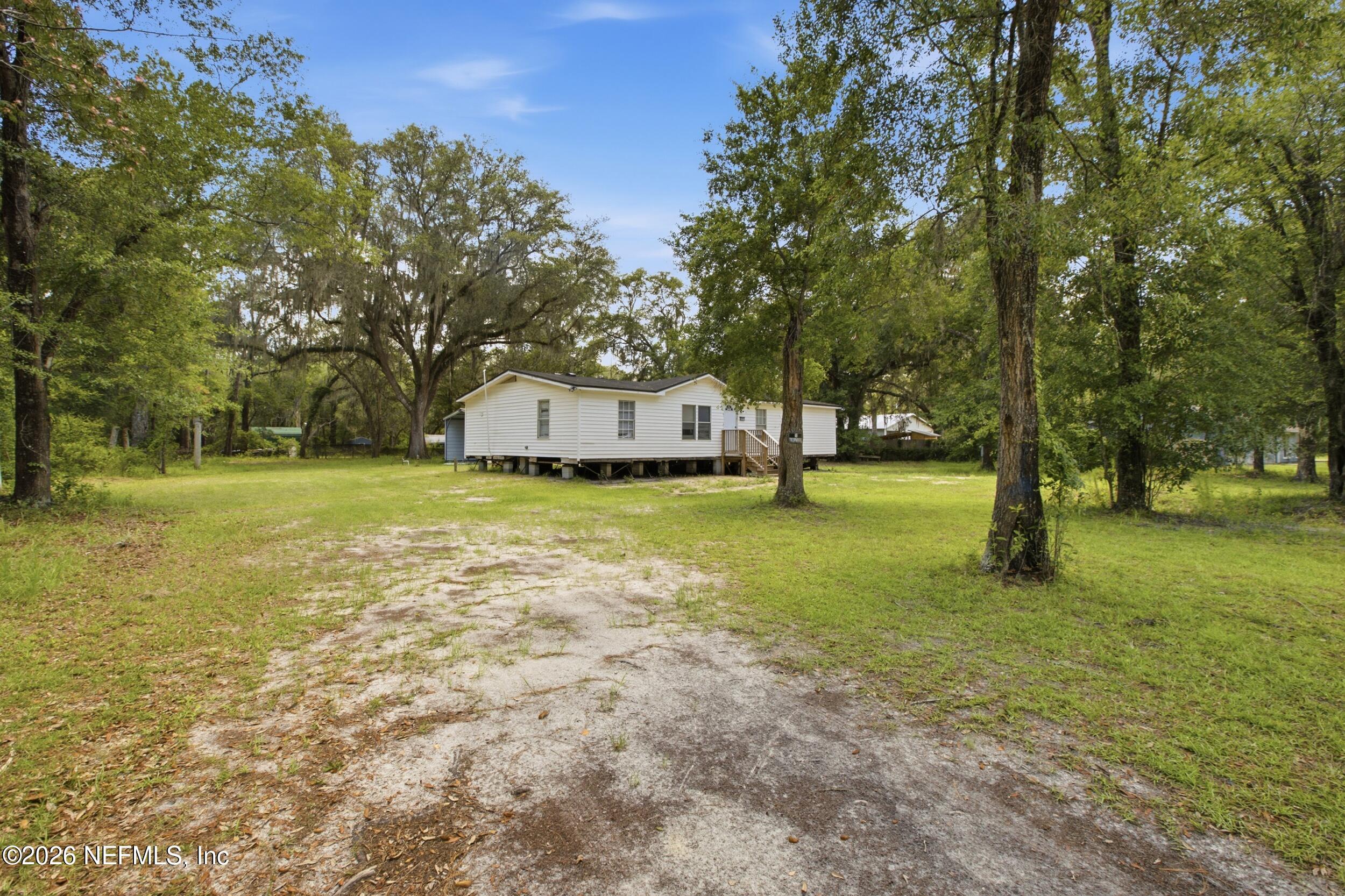 5667 Long Branch Cemetery Road Jacksonville, FL 32234 - Photo 22 of 24 a view of a house with yard and tree s