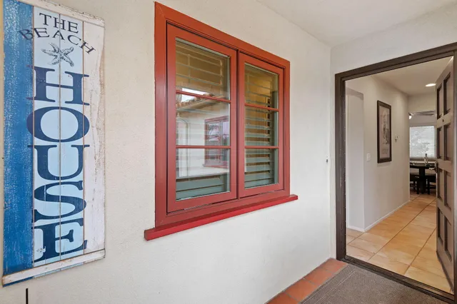 a view of an entryway with wooden floor and door