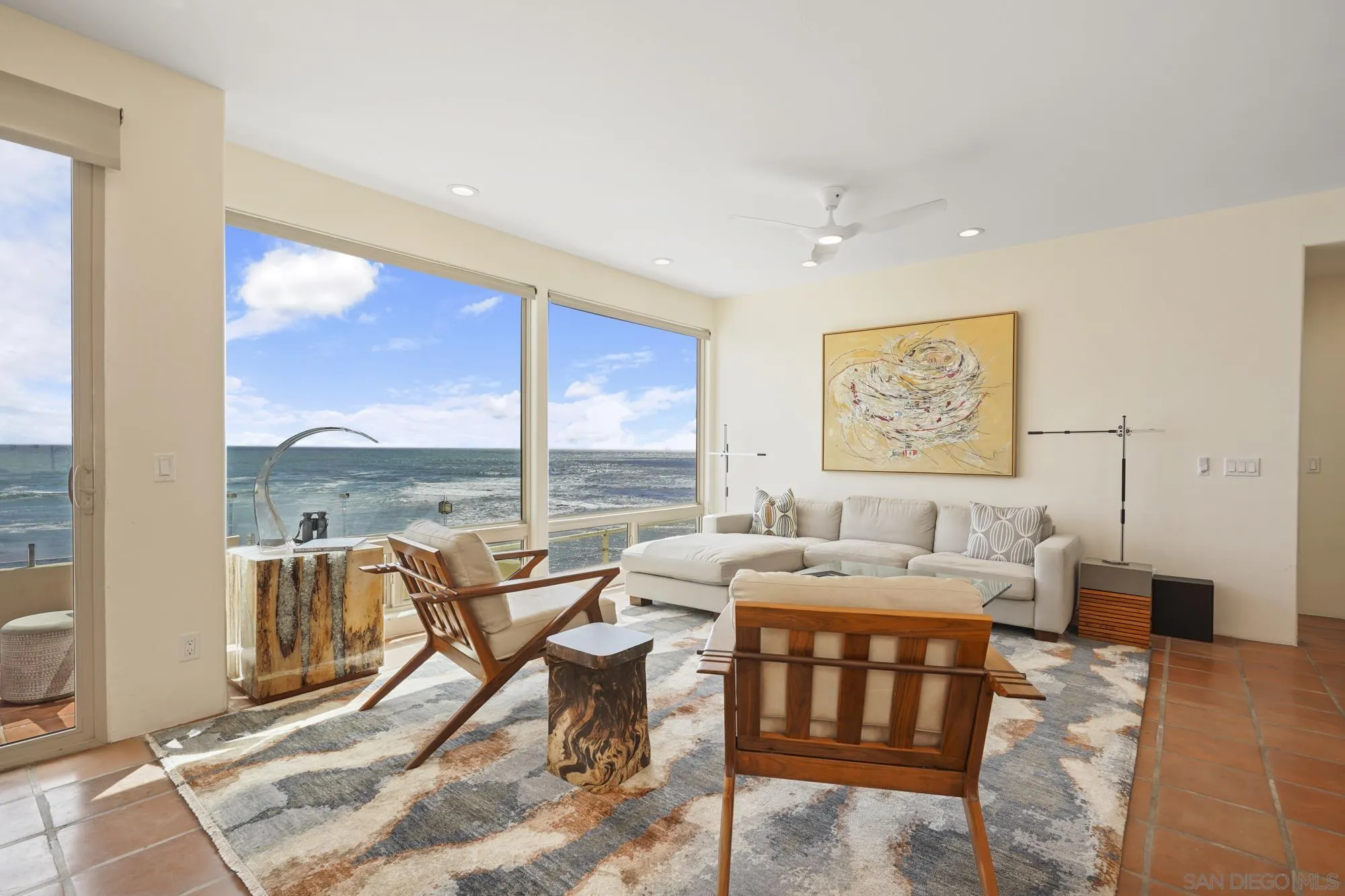 5650 Dolphin Place La Jolla, CA 92037 - Photo 15 of 54 a living room with furniture and a floor to ceiling window