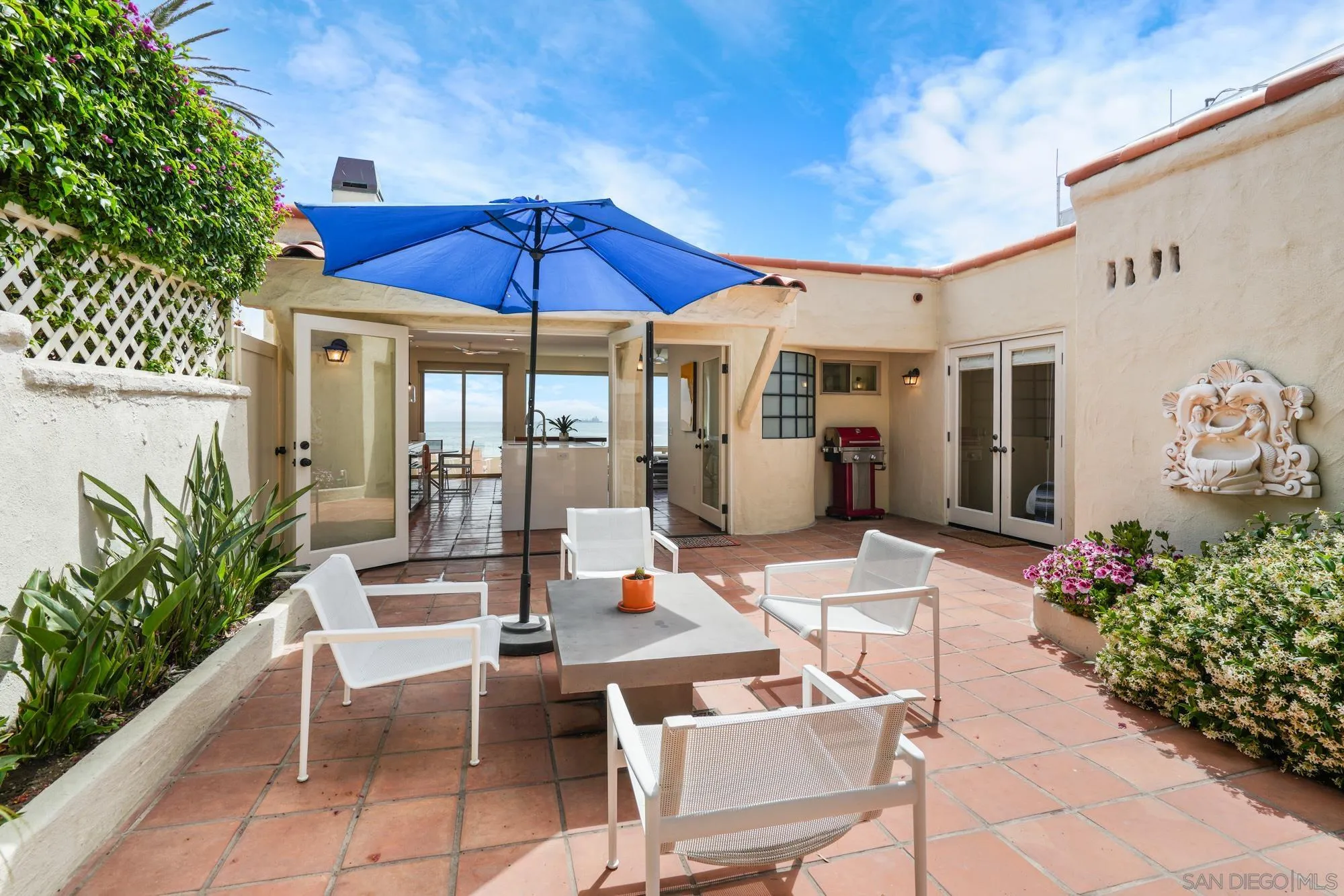 5650 Dolphin Place La Jolla, CA 92037 - Photo 27 of 54 a patio with a table and chairs under an umbrella
