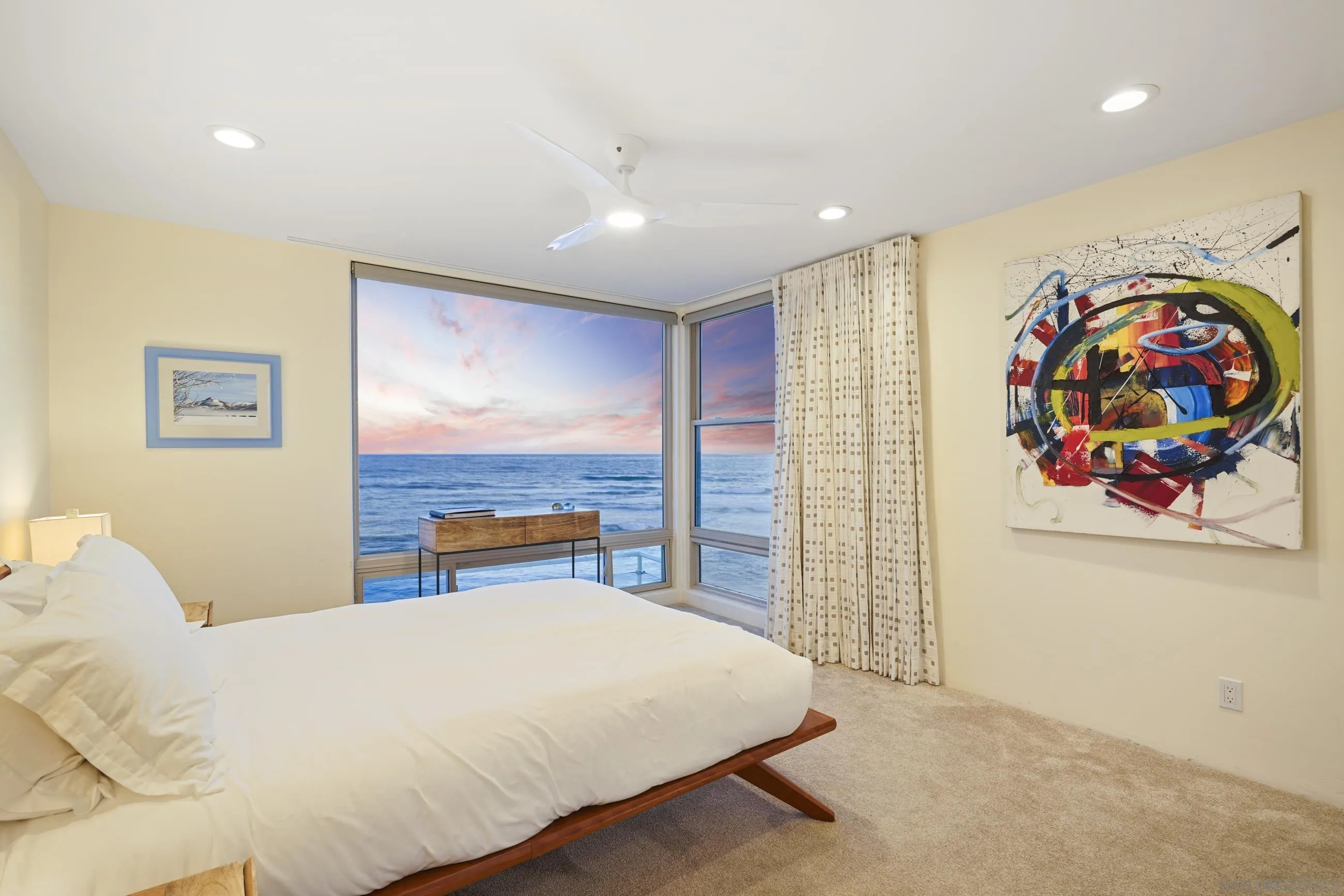 5650 Dolphin Place La Jolla, CA 92037 - Photo 28 of 54 a bedroom with a large bed and a painting