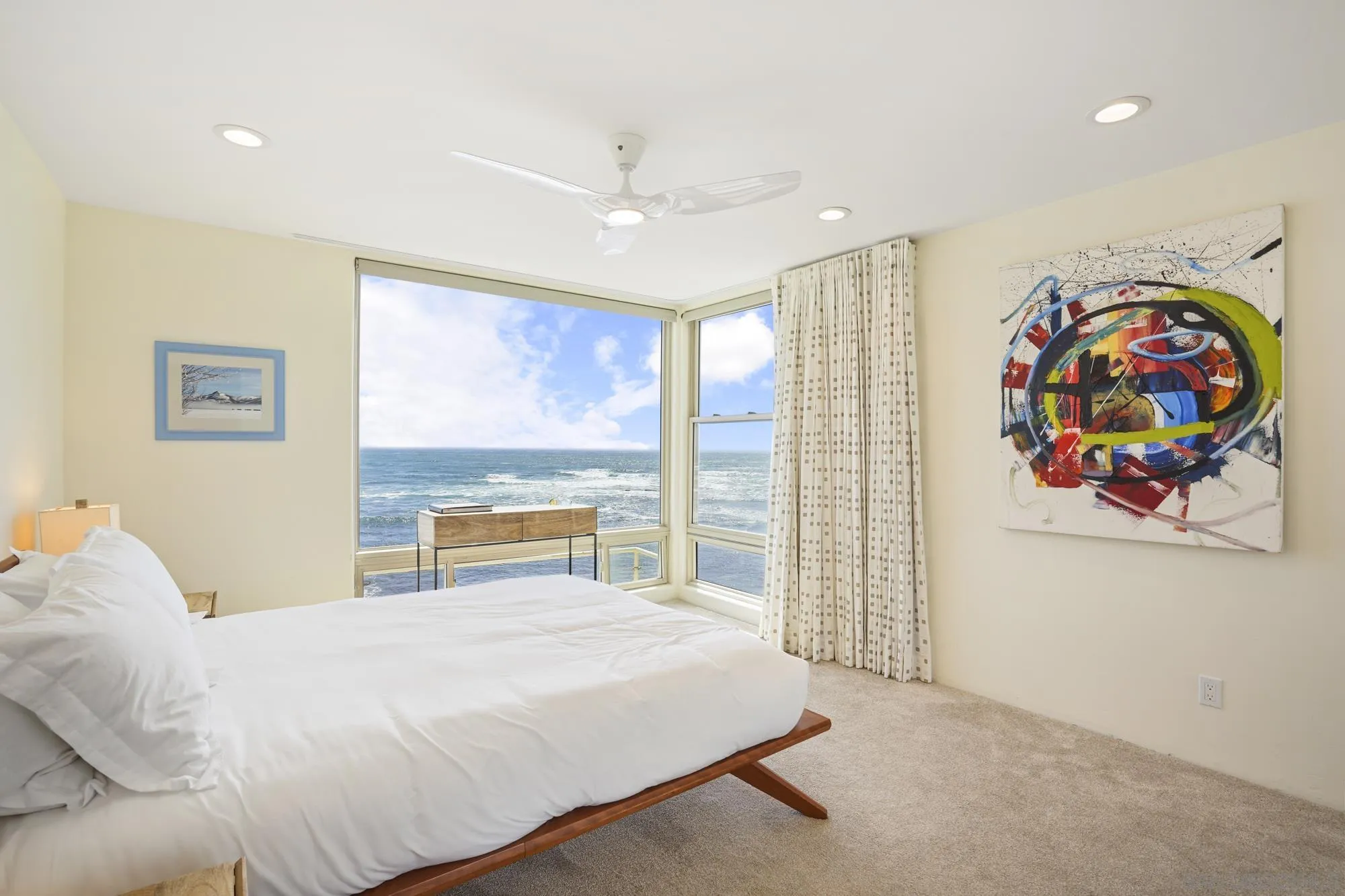 5650 Dolphin Place La Jolla, CA 92037 - Photo 29 of 54 a bedroom with a bed and a large window