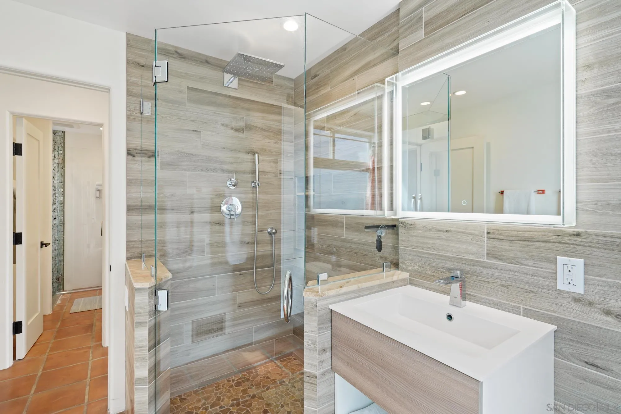5650 Dolphin Place La Jolla, CA 92037 - Photo 36 of 54 a bathroom with a shower sink and mirror