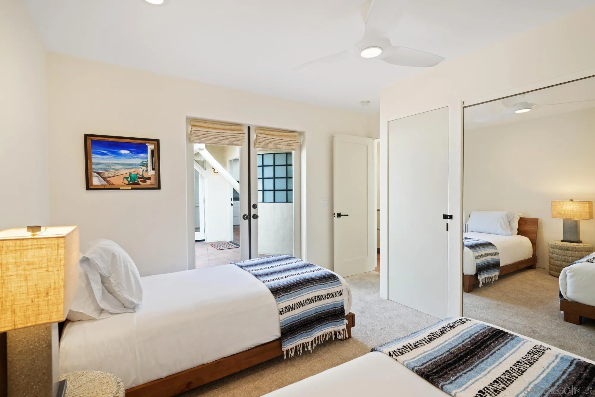 5650 Dolphin Place La Jolla, CA 92037 - Photo 37 of 54 a bedroom with a bed and wooden floor