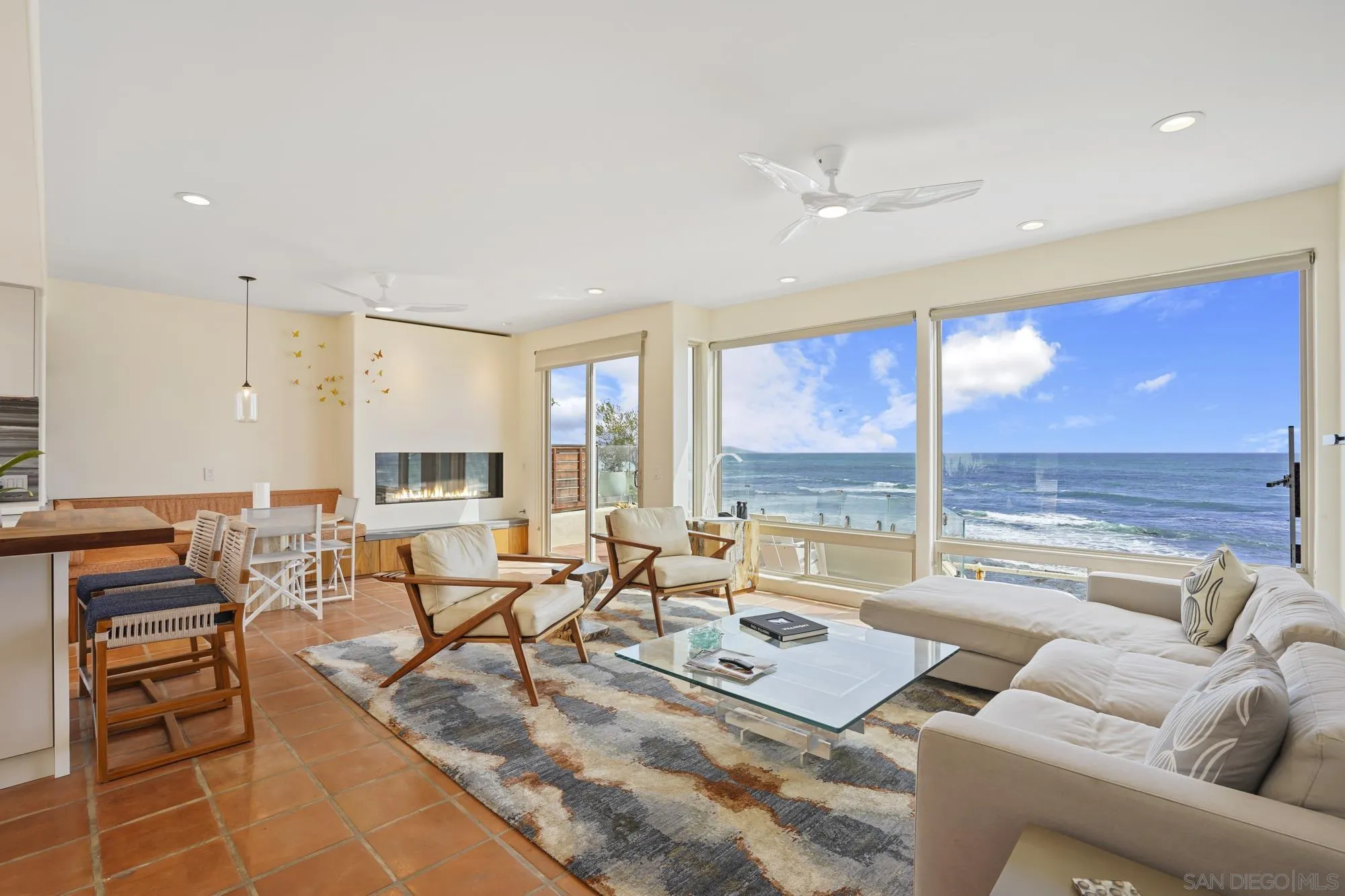 5650 Dolphin Place La Jolla, CA 92037 - Photo 5 of 54 a living room with furniture and large windows