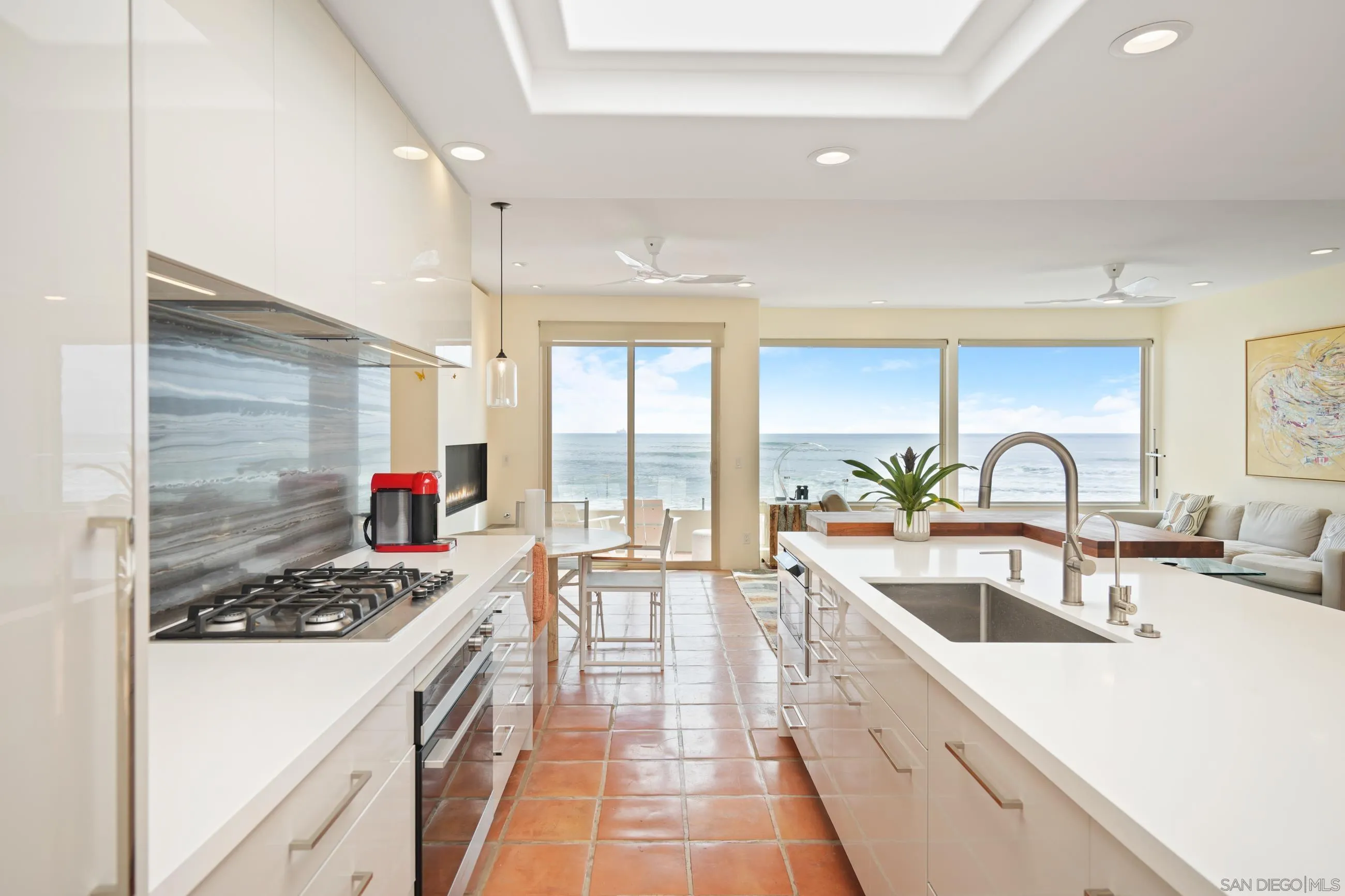 5650 Dolphin Place La Jolla, CA 92037 - Photo 8 of 54 a kitchen with sink a stove and cabinets