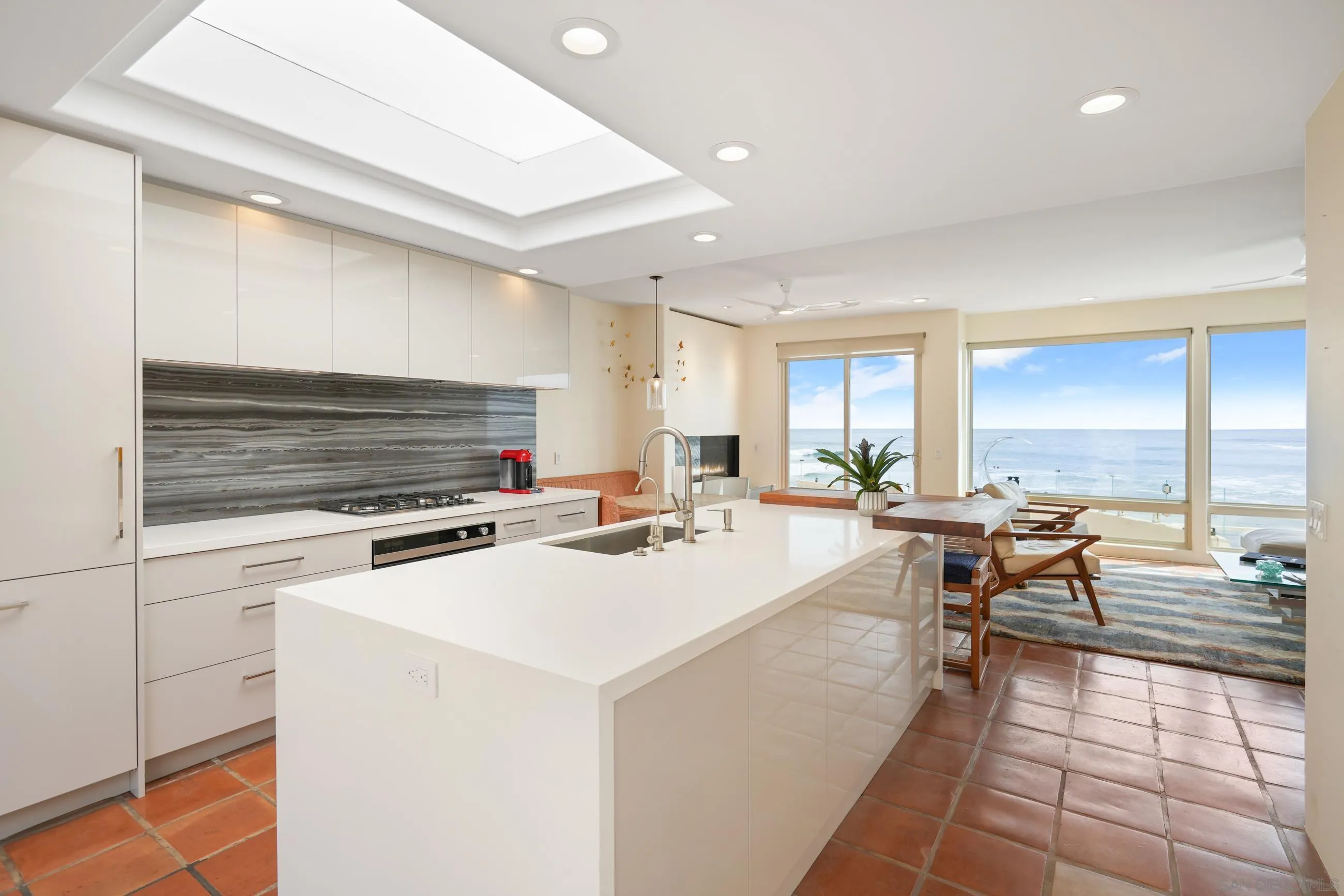 5650 Dolphin Place La Jolla, CA 92037 - Photo 9 of 54 a living room with furniture a flat screen tv and a stove
