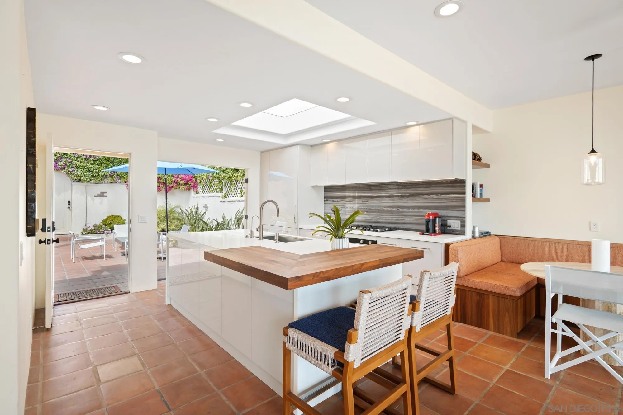 5650 Dolphin Place La Jolla, CA 92037 - Photo 10 of 54 a room with stainless steel appliances kitchen island granite countertop a sink and chairs