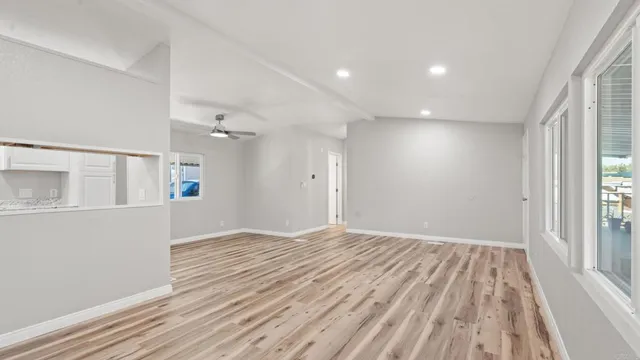wooden floor in an empty room with a window