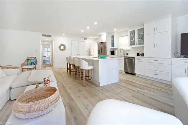a living room with furniture and kitchen view