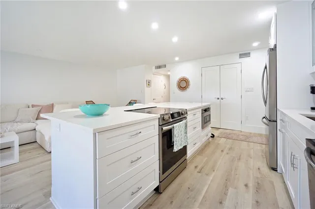 a kitchen with a stove a sink and a refrigerator