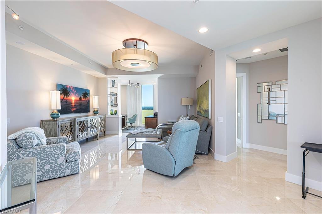 295 Grande Way, Unit PH2 Naples, FL 34110 - Photo 13 of 45 a living room with furniture and a flat screen tv