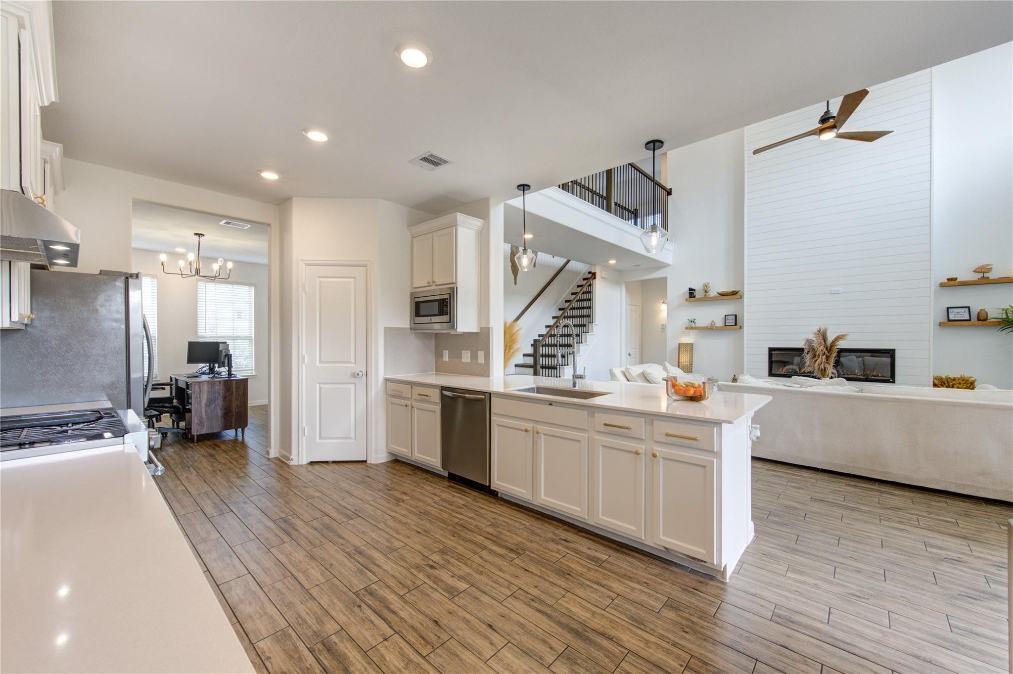 17530 Sunset Skies Road Conroe, TX 77302 - Photo 18 of 47 a kitchen with stainless steel appliances kitchen island granite countertop a stove a sink and a refrigerator
