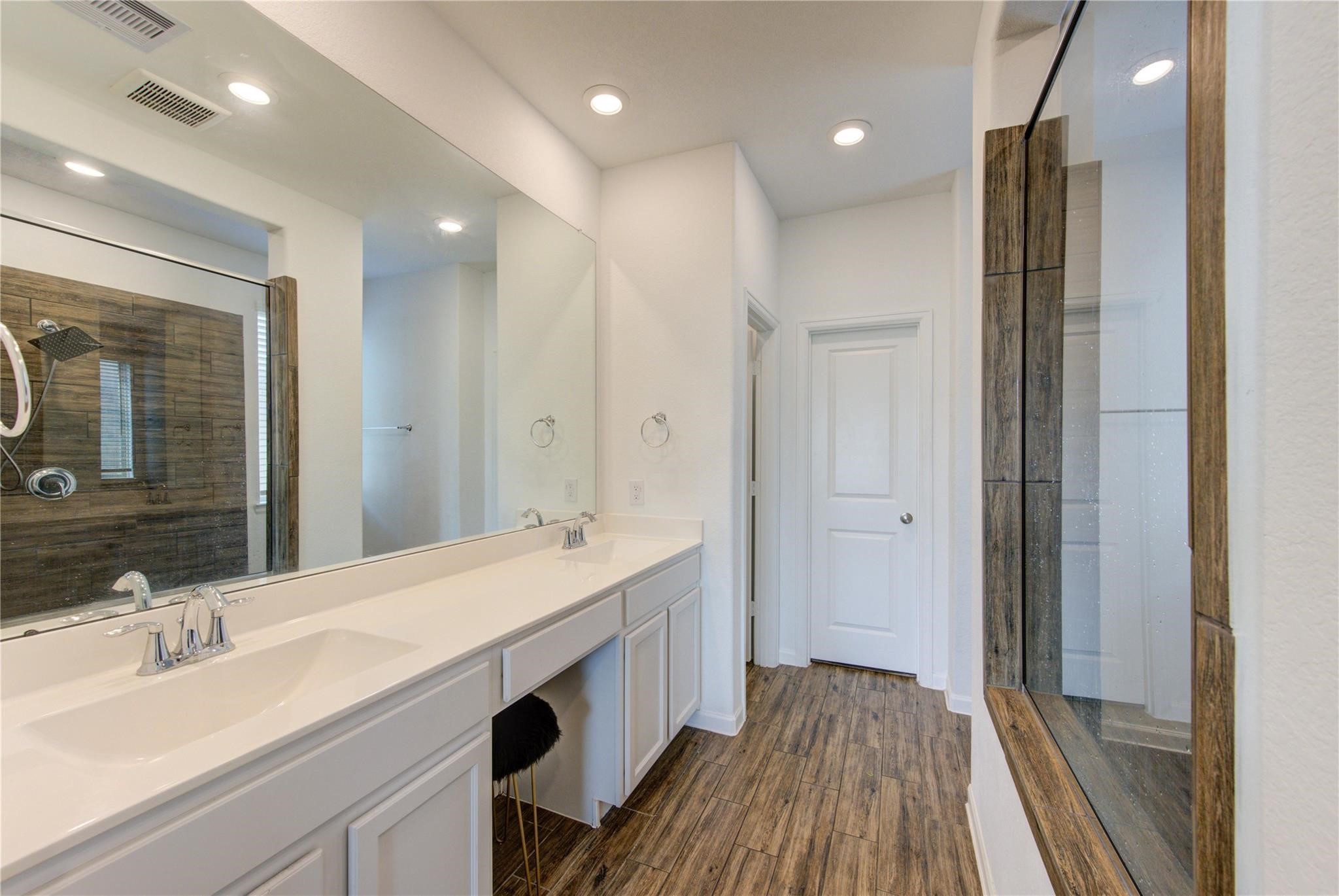17530 Sunset Skies Road Conroe, TX 77302 - Photo 24 of 47 a spacious bathroom with a double vanity sink a mirror and shower