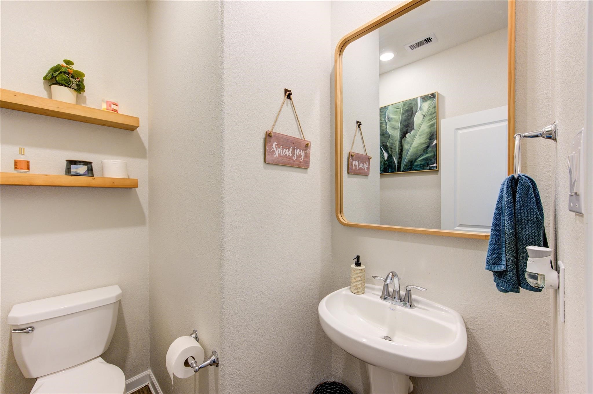 17530 Sunset Skies Road Conroe, TX 77302 - Photo 28 of 47 a bathroom with a toilet sink and mirror
