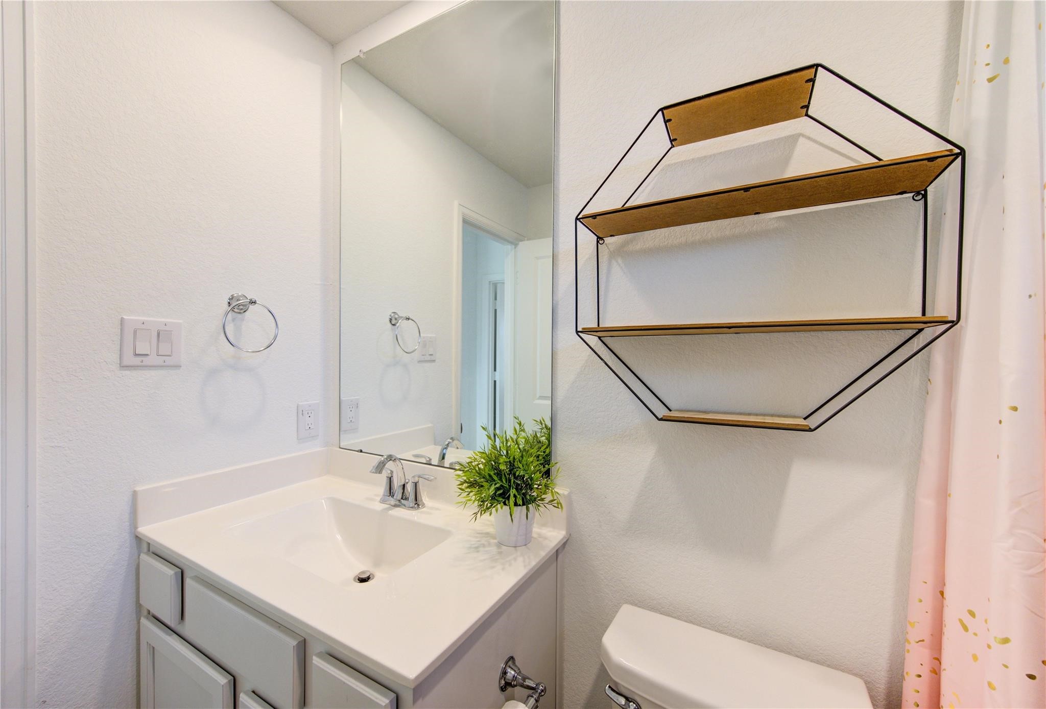 17530 Sunset Skies Road Conroe, TX 77302 - Photo 38 of 47 a bathroom with a sink toilet and mirror