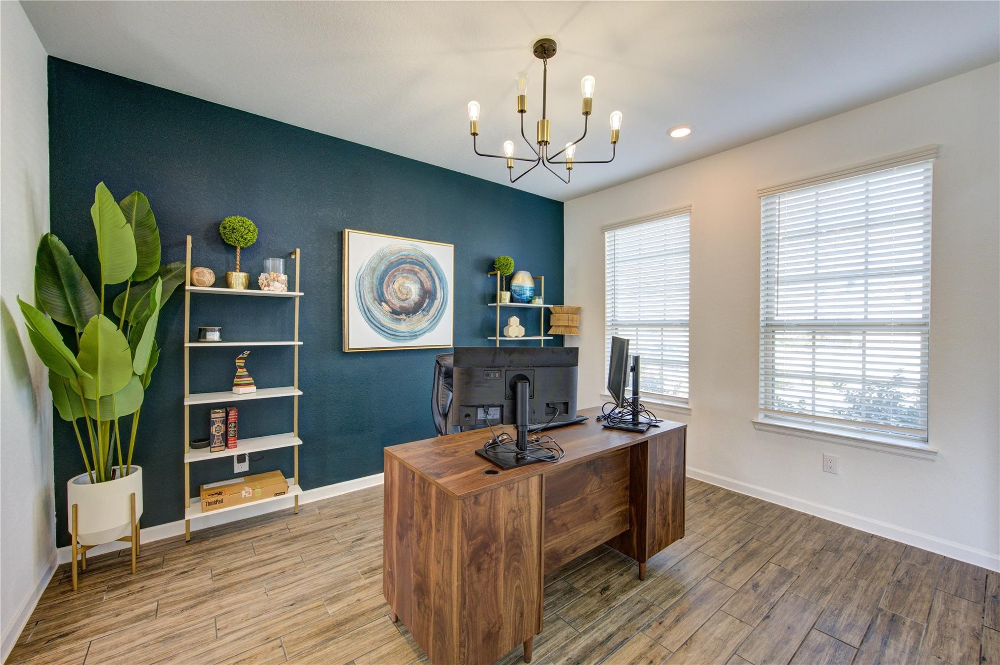17530 Sunset Skies Road Conroe, TX 77302 - Photo 4 of 47 a living room with furniture a chandelier and a bookshelf