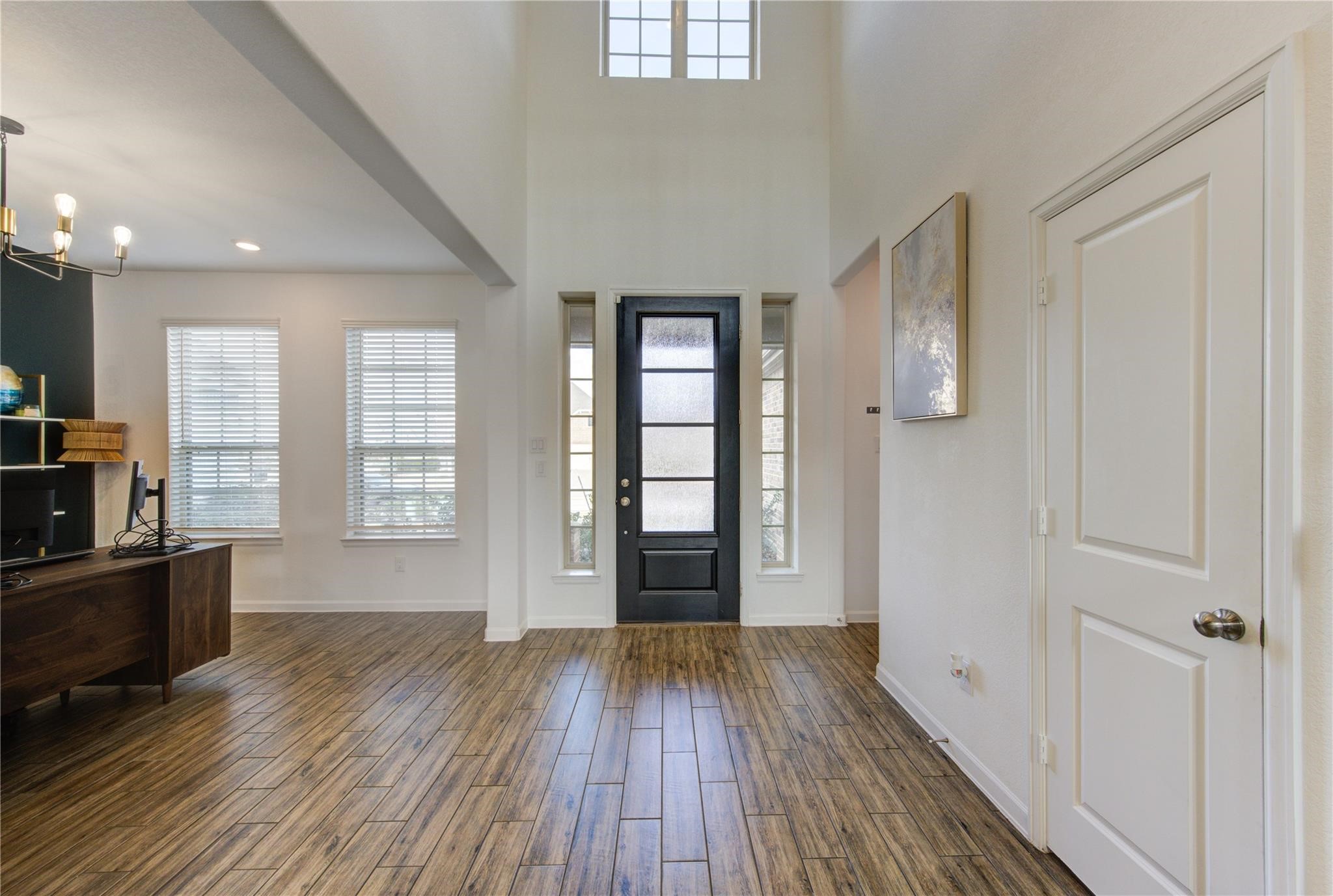 17530 Sunset Skies Road Conroe, TX 77302 - Photo 6 of 47 an empty room with wooden floor and windows