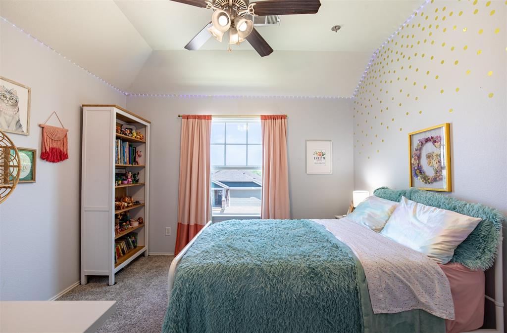 416 Allbright Road Celina, TX 75009 - Photo 25 of 40 a bedroom with a bed and a bookshelf