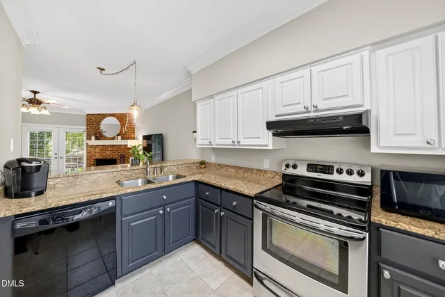 a kitchen with stainless steel appliances granite countertop a sink stove and cabinets