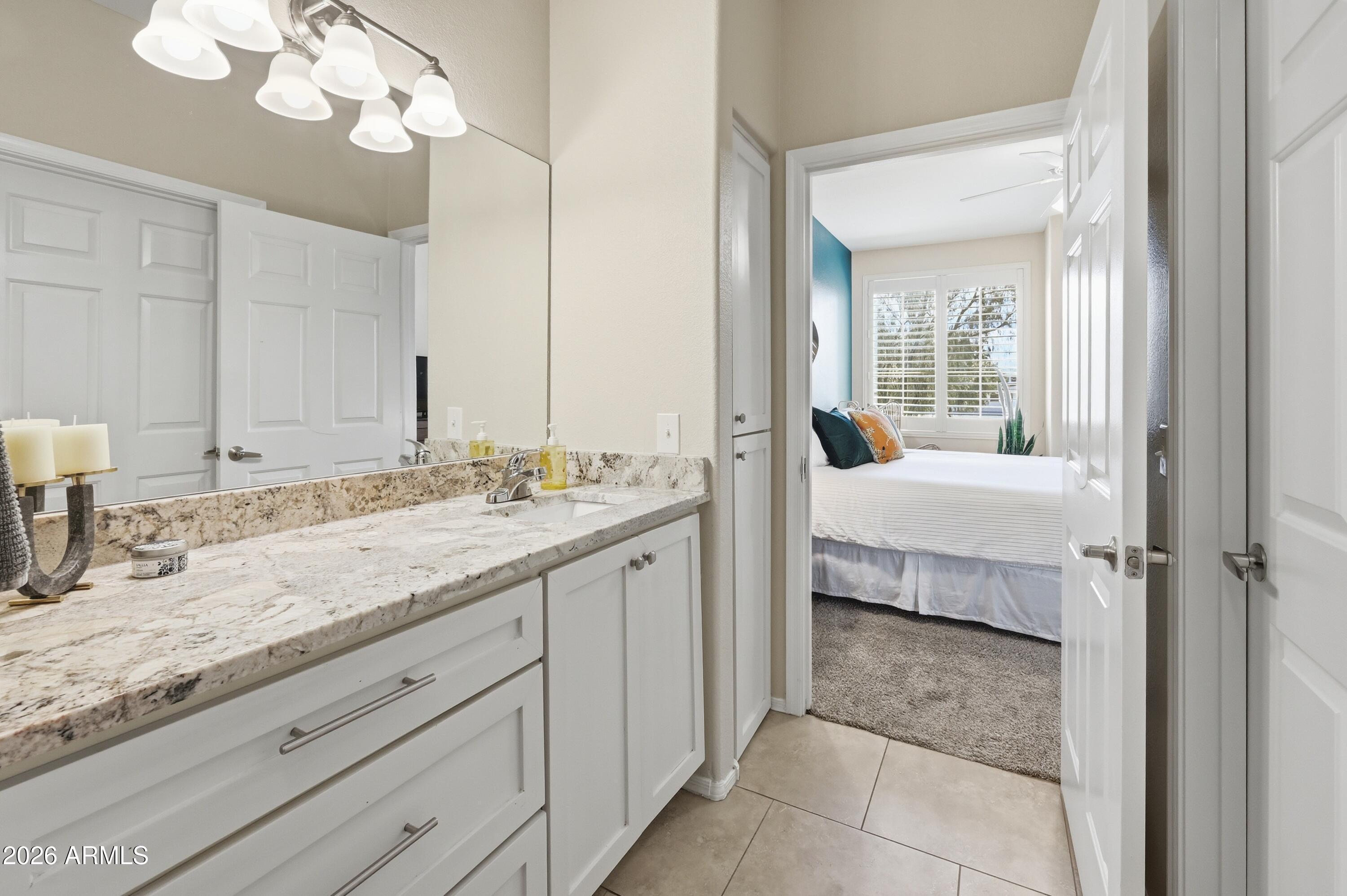 5303 North 7th Street, Unit 220 Phoenix, AZ 85014 - Photo 20 of 33 a en suite bathroom with a granite countertop sink and a mirror