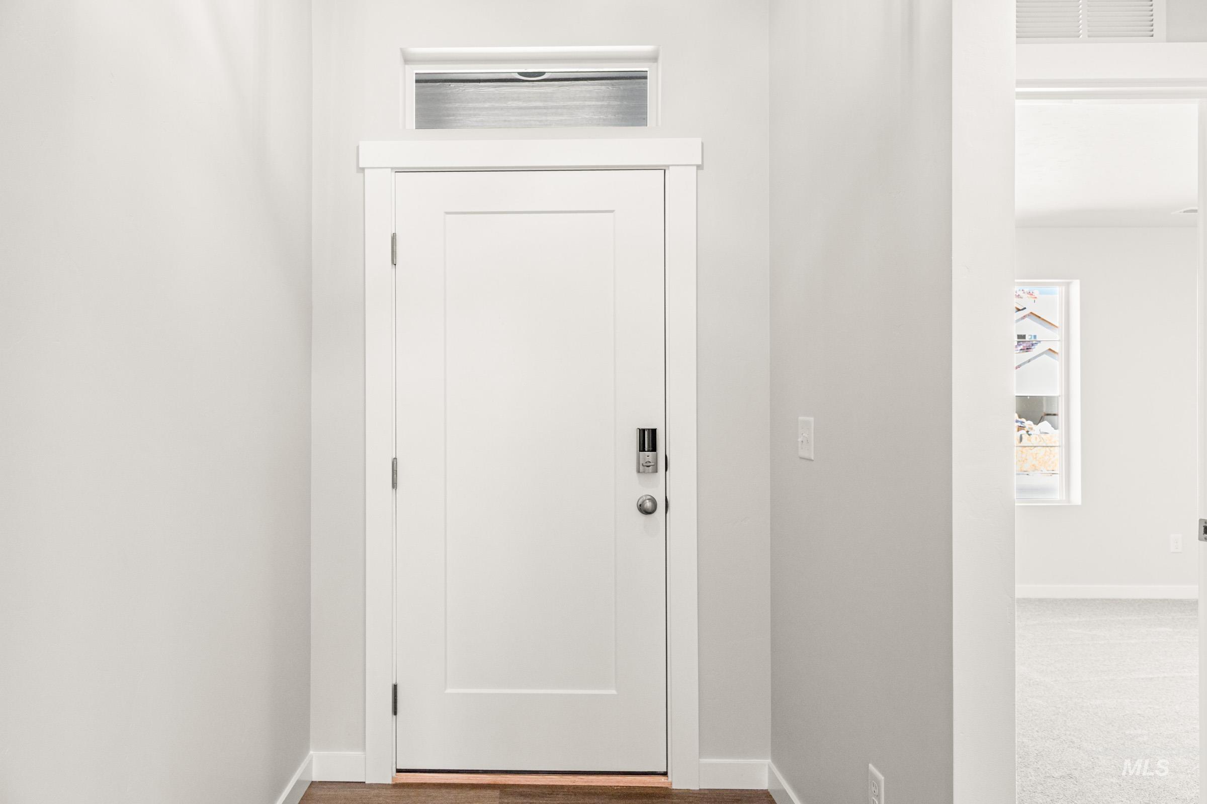 1077 West Jasper Street Meridian, ID 83642 - Photo 2 of 19 Entryway featuring a white paneled door with contemporary hardware and a transom window