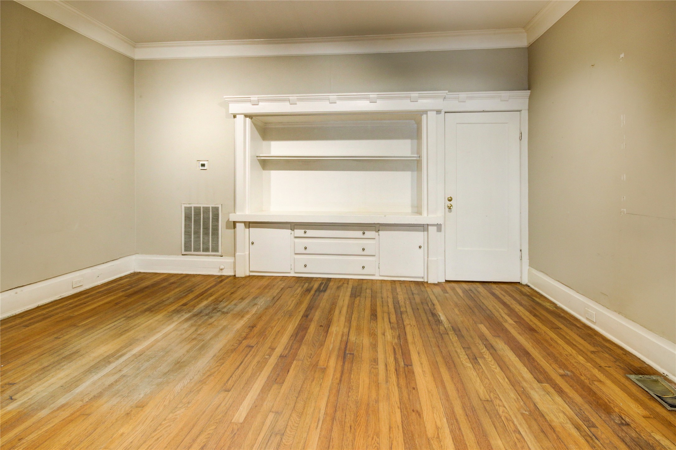 239 Westheimer Road Houston, TX 77006 - Photo 12 of 50 a view of an empty room with wooden floor and a window