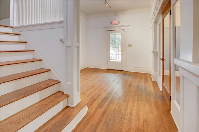 a view of entryway with wooden floor and stairs