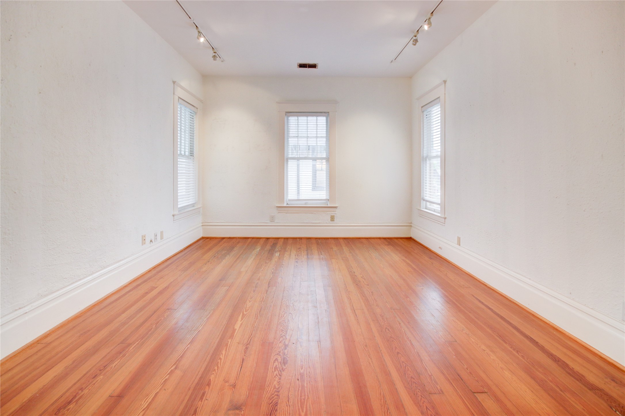239 Westheimer Road Houston, TX 77006 - Photo 25 of 50 an empty room with wooden floor and windows