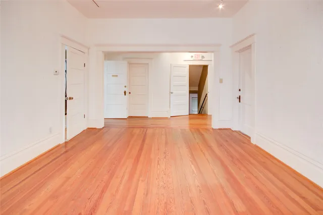 a view of a room with wooden floor and brick walls
