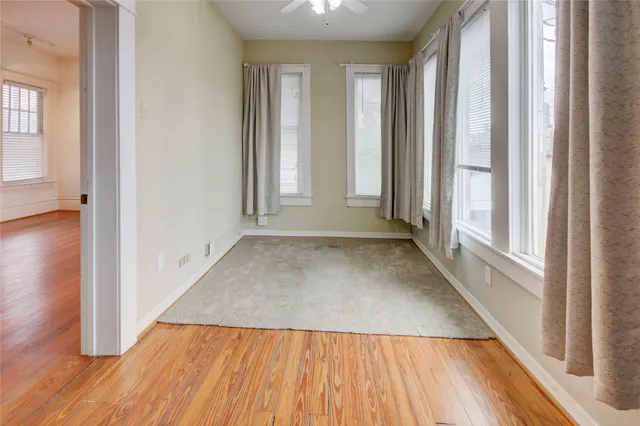 an entryway with wooden floor and windows