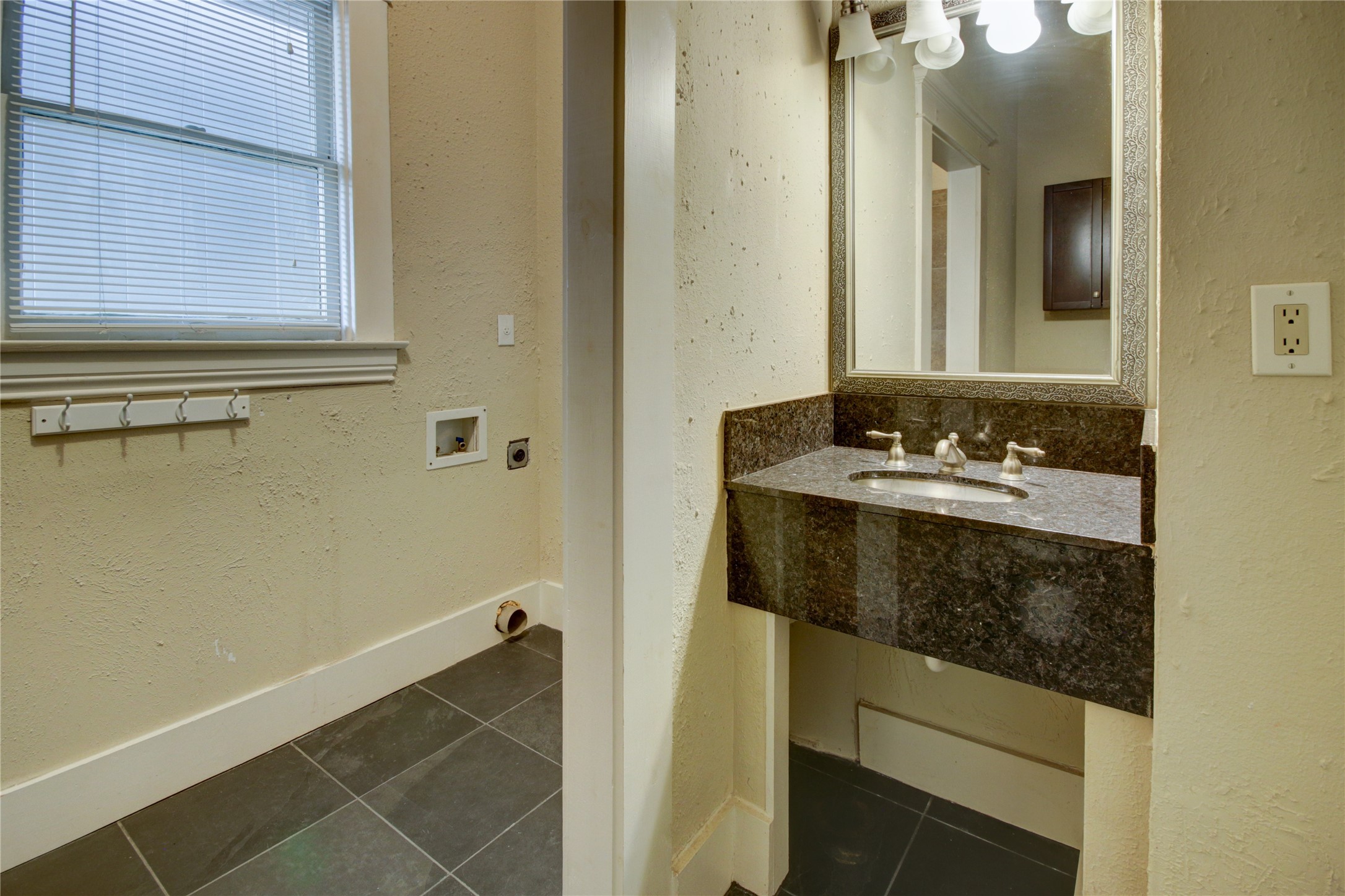 239 Westheimer Road Houston, TX 77006 - Photo 31 of 50 a bathroom with a sink and a mirror