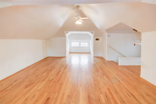 a view of a hallway with wooden floor and front door