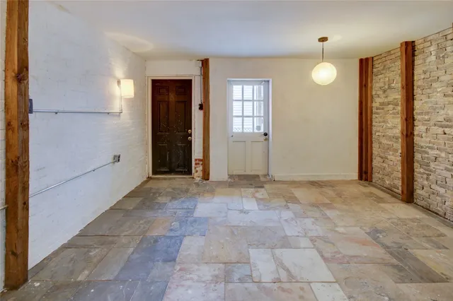 an empty room with windows and closet