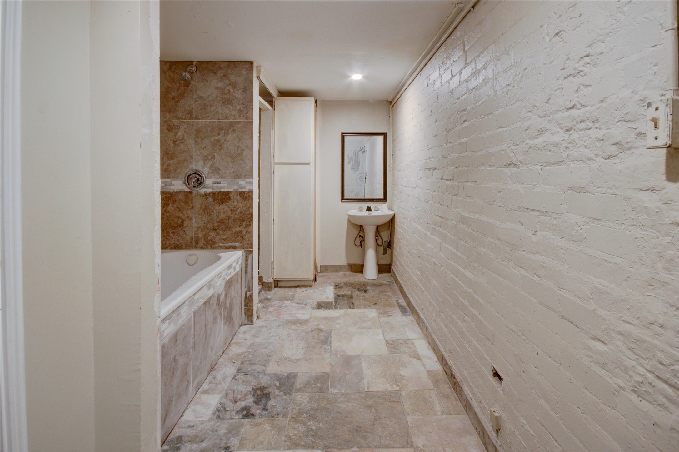 239 Westheimer Road Houston, TX 77006 - Photo 42 of 50 a bathroom with a granite countertop bathtub shower and mirror