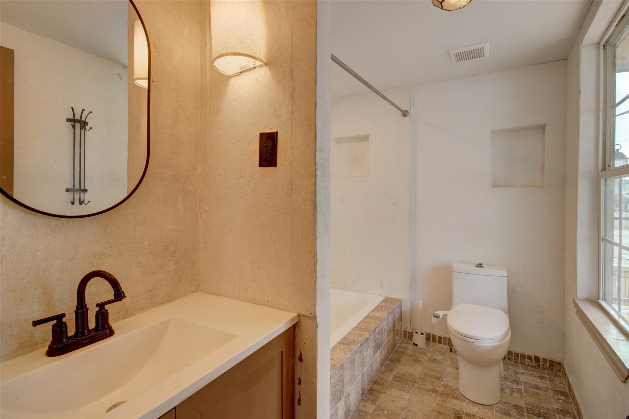 239 Westheimer Road Houston, TX 77006 - Photo 47 of 50 a bathroom with a toilet sink and mirror