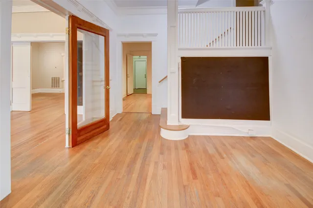 a view of hallway with wooden floor
