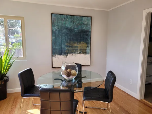 a view of a workspace with furniture and a window