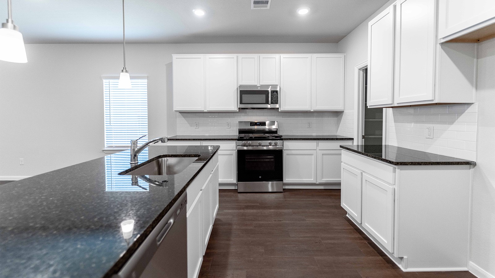 1539 Windrose Bend Angleton, TX 77515 - Photo 3 of 13 a kitchen with white cabinets appliances and sink