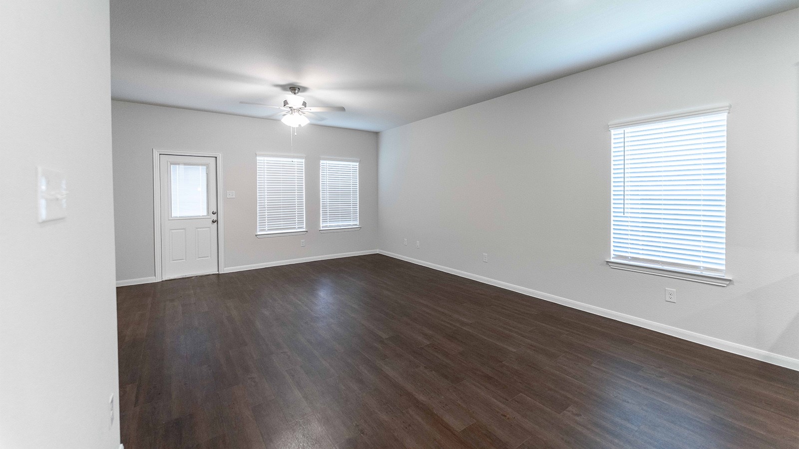 1539 Windrose Bend Angleton, TX 77515 - Photo 5 of 13 a view of an empty room with wooden floor and a window