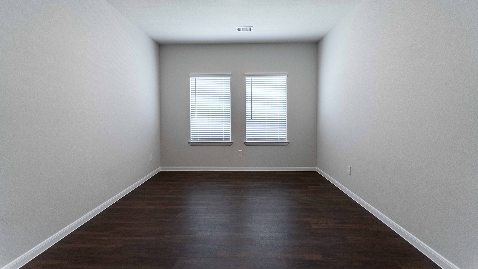 1539 Windrose Bend Angleton, TX 77515 - Photo 7 of 13 an empty room with wooden floor and windows