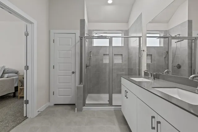 a bathroom with a granite countertop sink mirror and shower