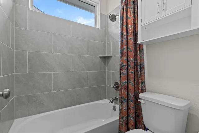 a bathroom with a bathtub and a toilet