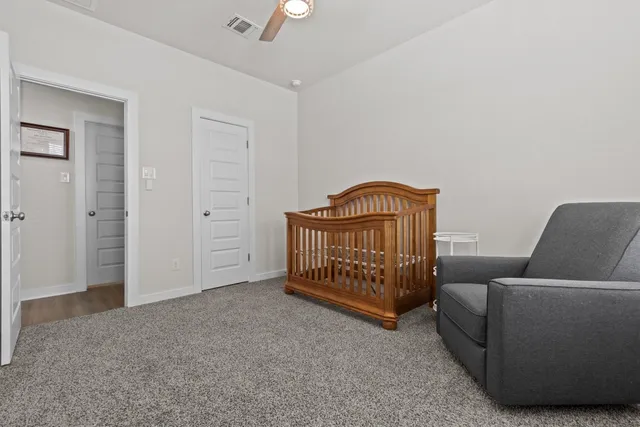 a bedroom with furniture and a baby crib