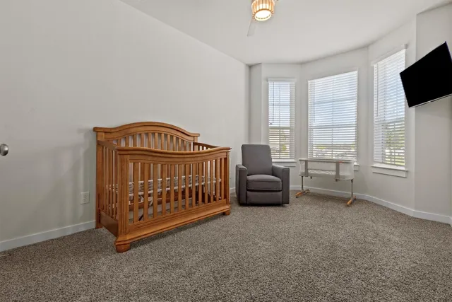 a bedroom with furniture and a window