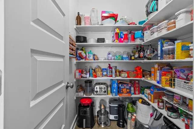 a utility room with lots of different colored cloths